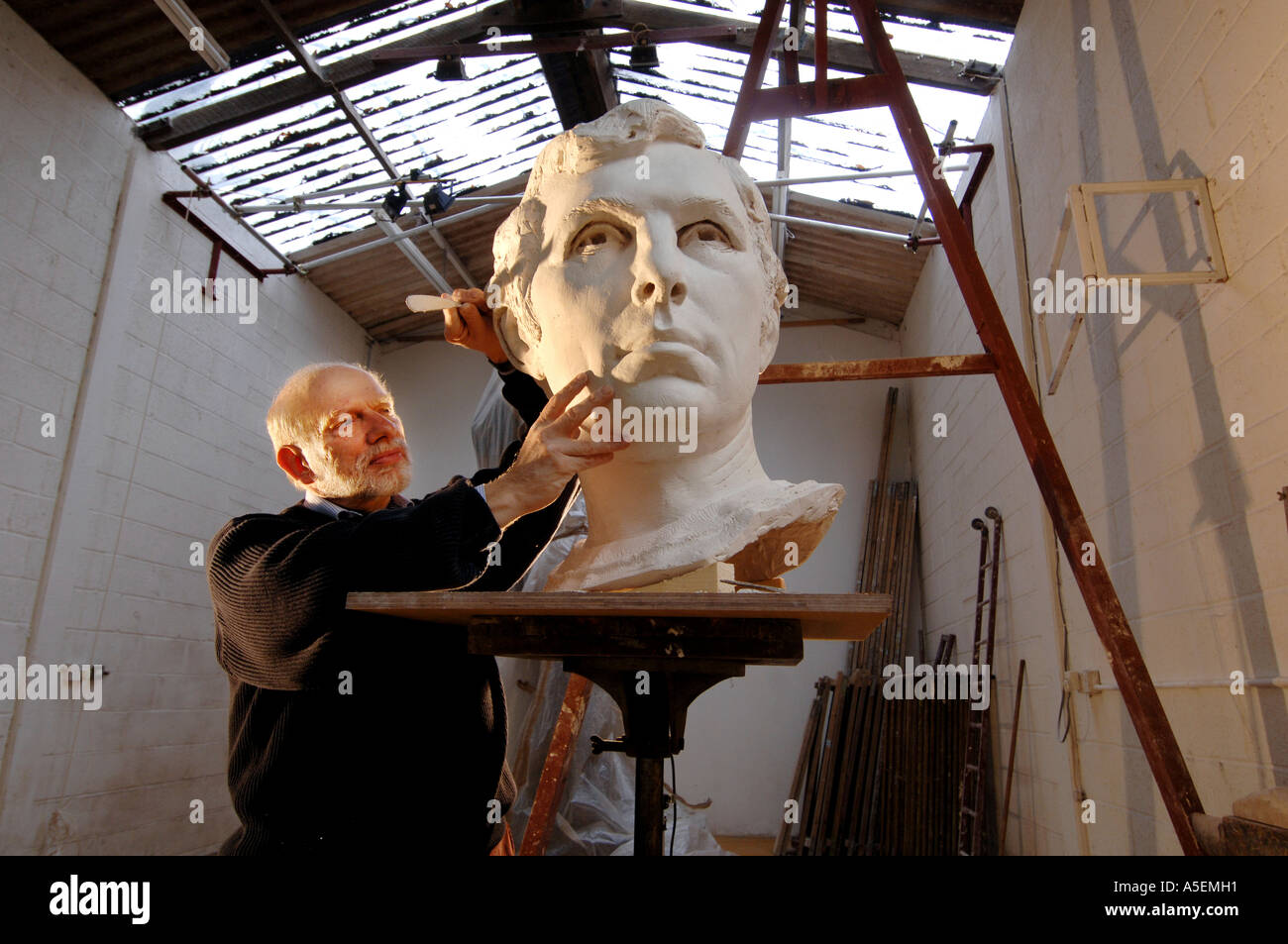 Sculptor Philip Jackson works on a portrait of footballer Bobby Moore