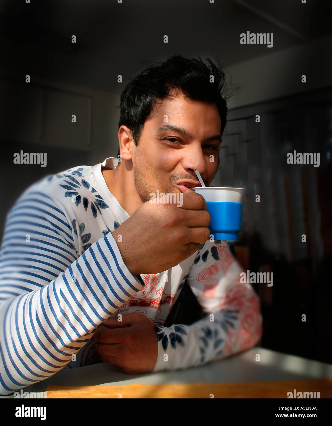 Man sipping coffee smiling Stock Photo