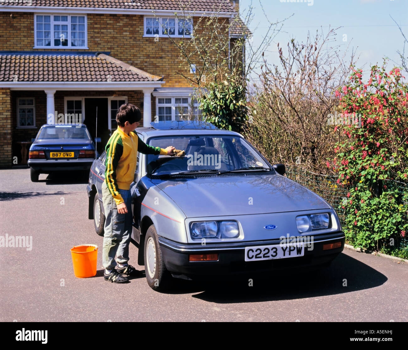Boy Cleaning and washing Ford Sierra Hatchback car Stock Photo Alamy
