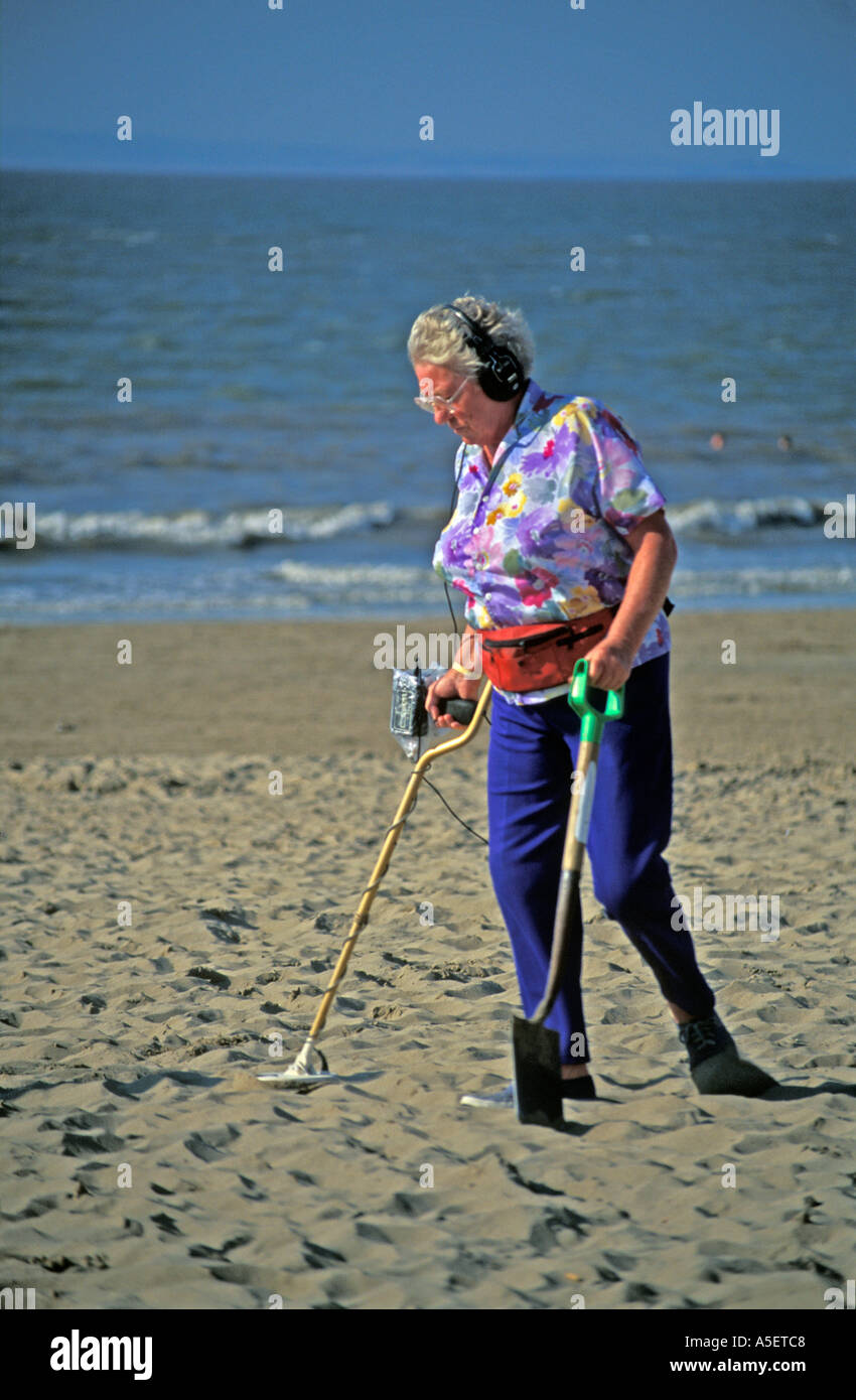 woman on beach using metal detector Stock Photo Alamy