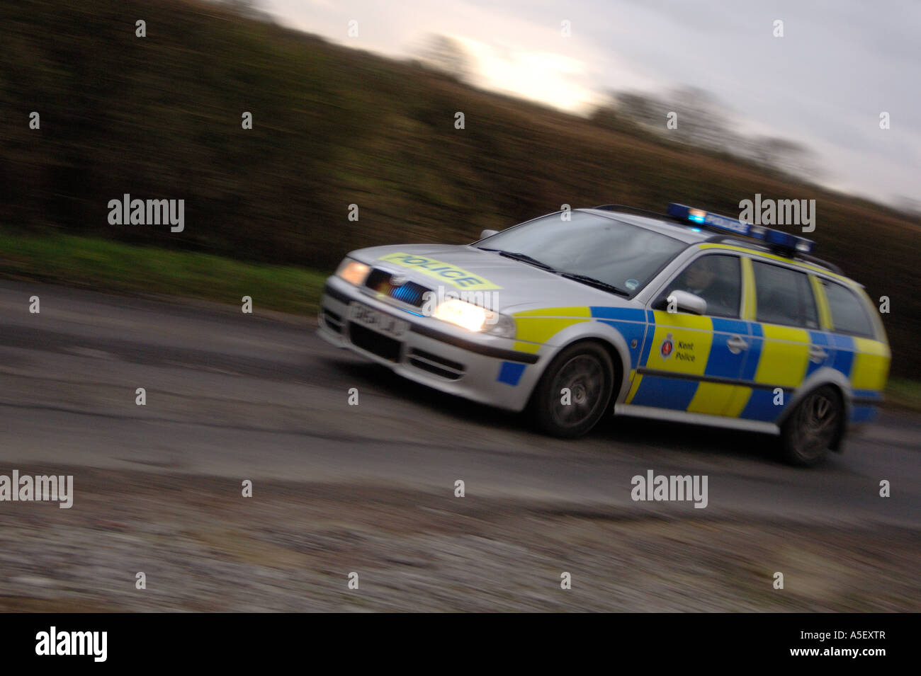 Police car races to emergency with lights flashing Stock Photo
