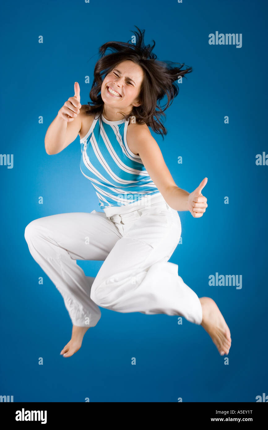 jumping happy woman on the blue background Stock Photo - Alamy