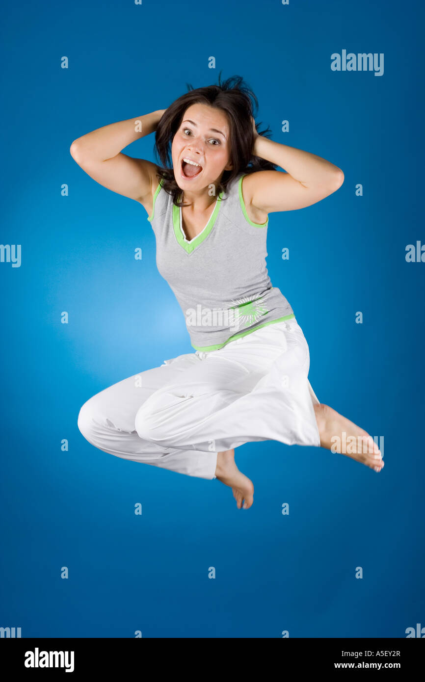jumping happy woman on the blue background Stock Photo - Alamy
