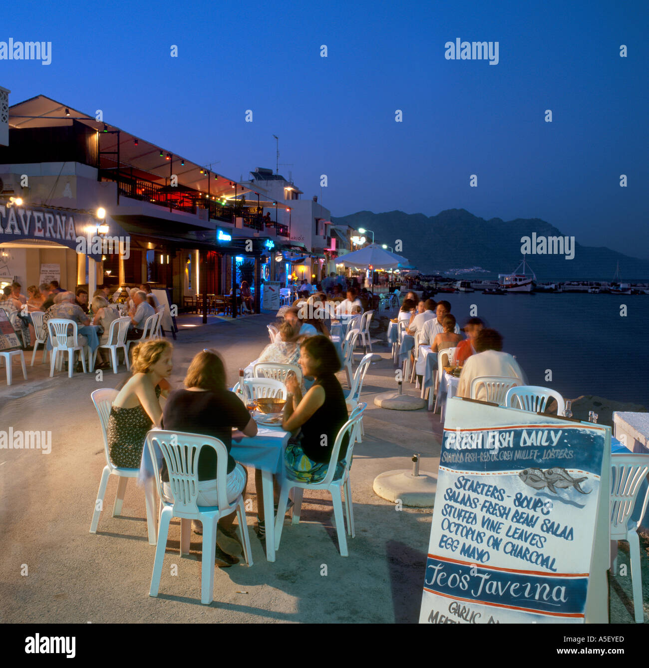 Seafront taverna at night, Kardamena, Kos, Dodecanese Islands, Greece Stock Photo