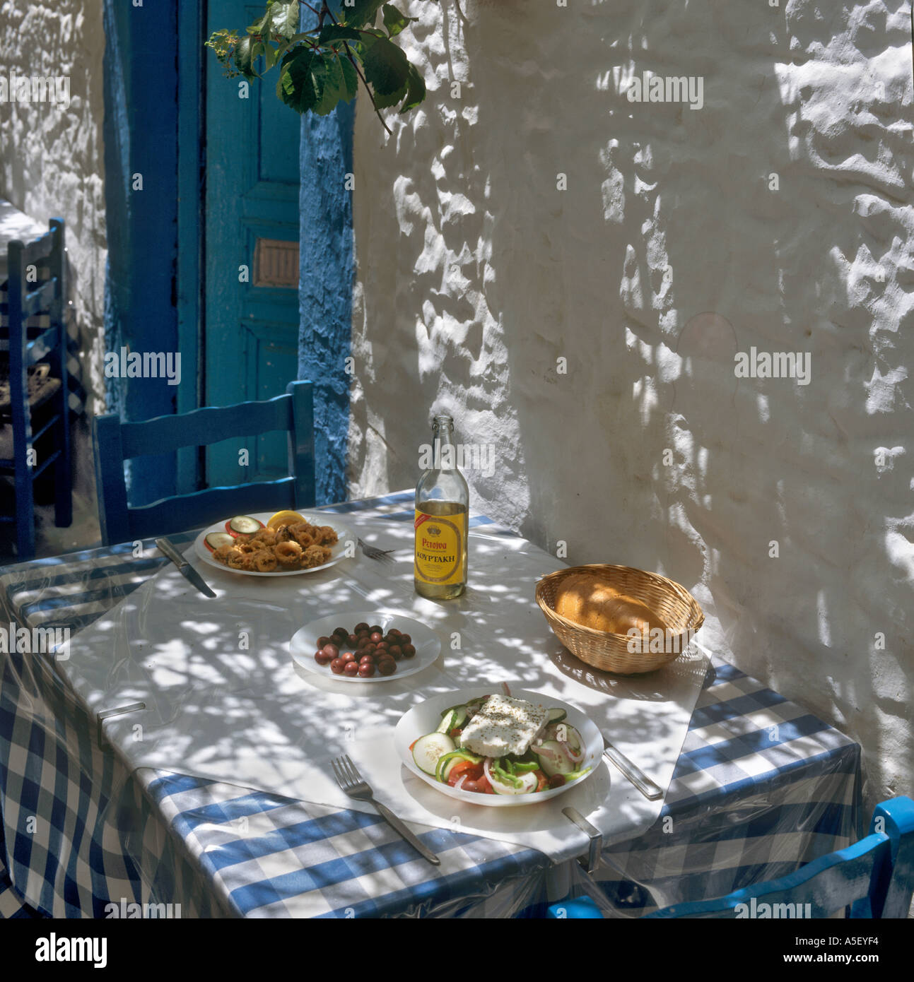 Greek food and wine in a traditional taverna in the village of Zia, Kos, Dodecanese Islands, Greece Stock Photo
