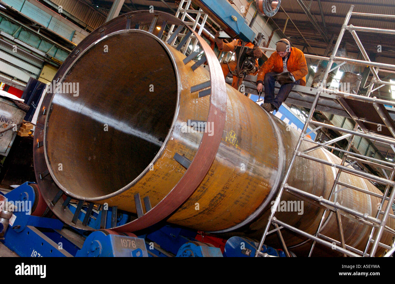 Engineers fabricate part of a steel foot and cycle bridge to cross the River Usk at Newport Gwent South Wales UK Stock Photo