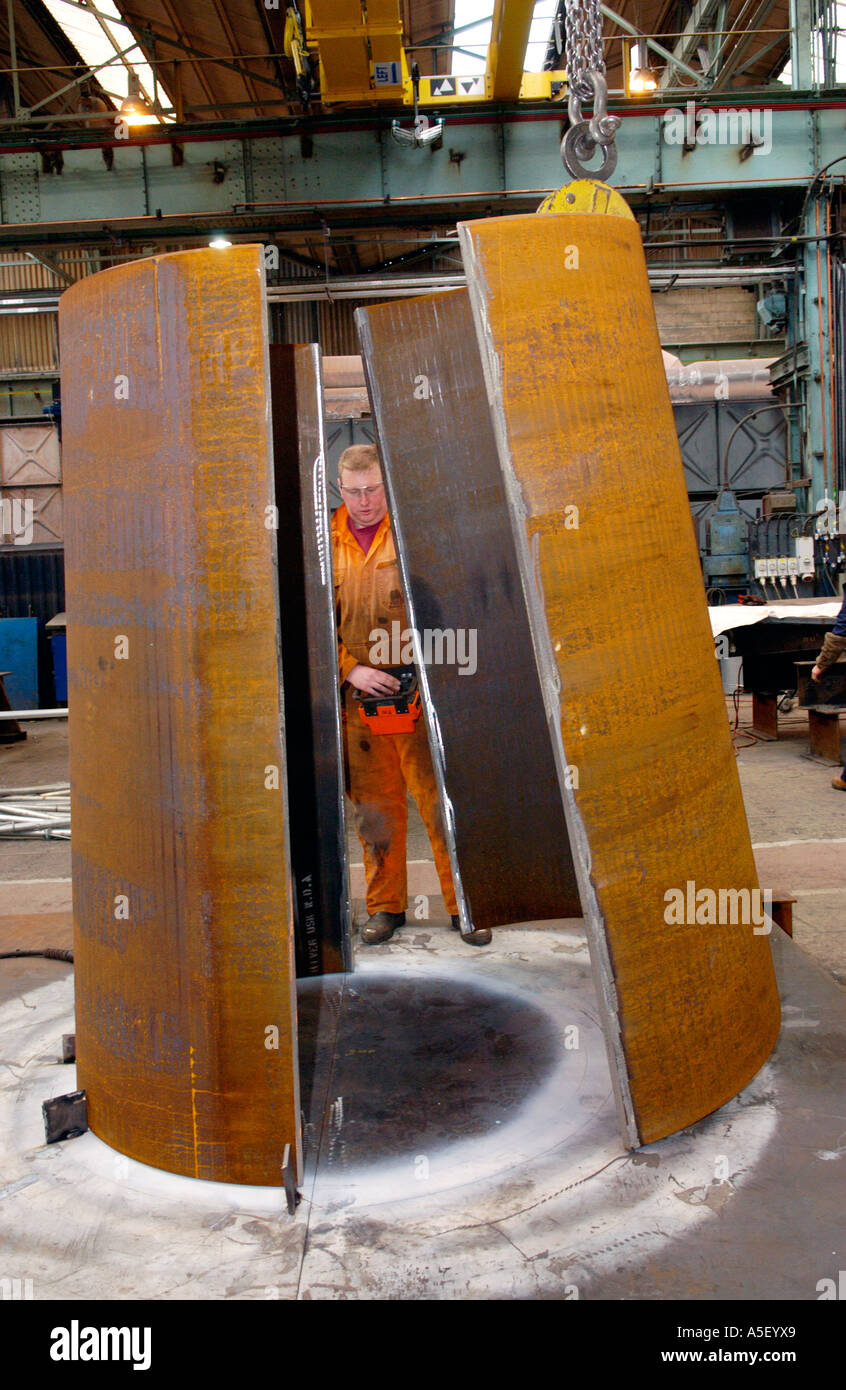 Engineers fabricate part of a steel foot and cycle bridge to cross the River Usk at Newport Gwent South Wales UK Stock Photo