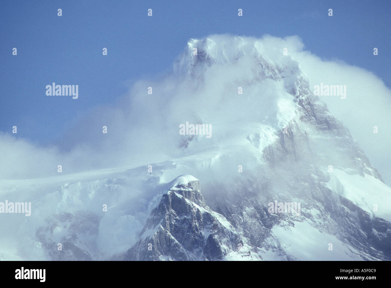 Mountain peak partially shrouded in cloud Stock Photo - Alamy