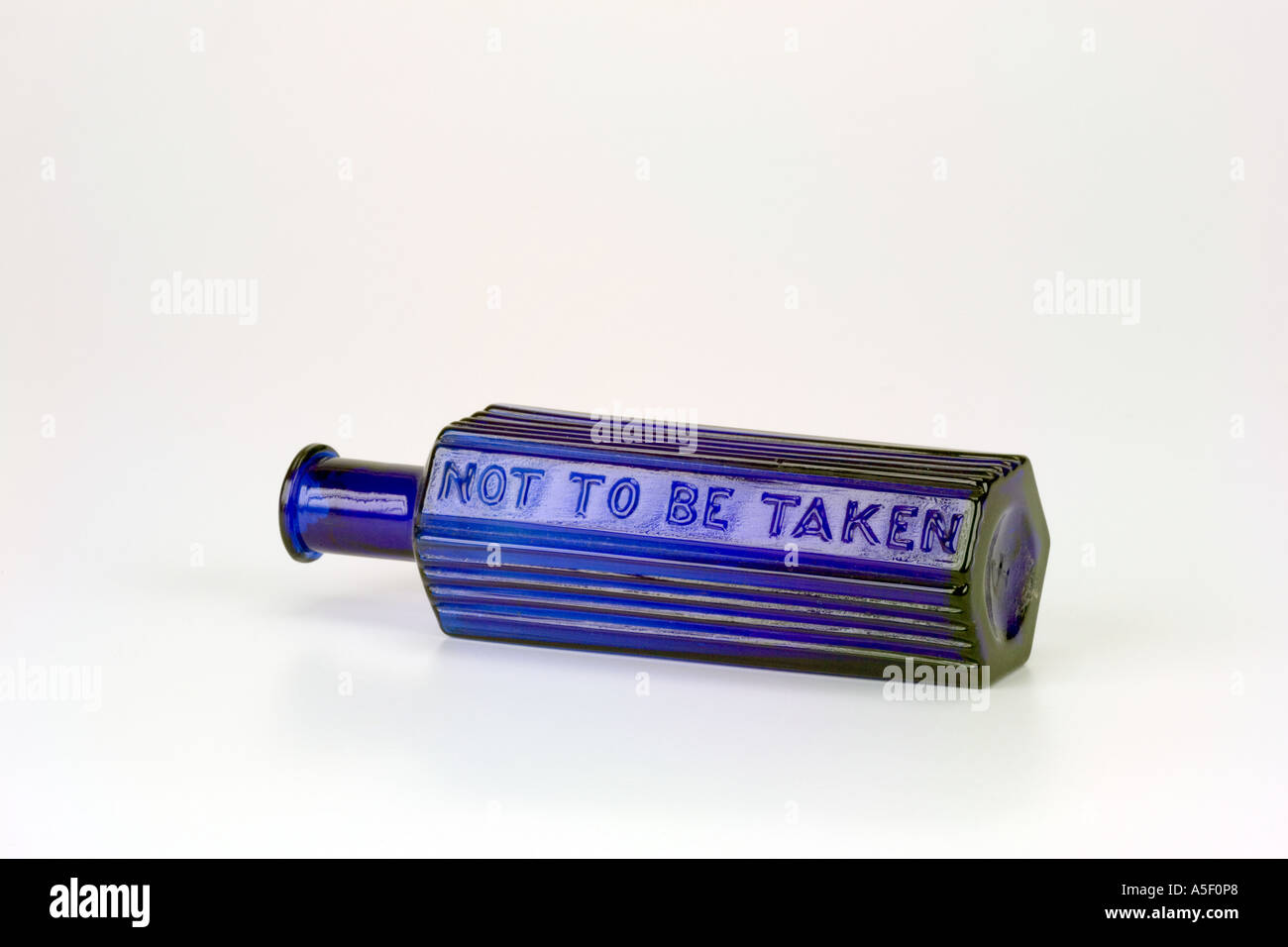 Blue Glass Antique Poison Bottle With Not To Be Taken Warning Sign Stock Photo Alamy