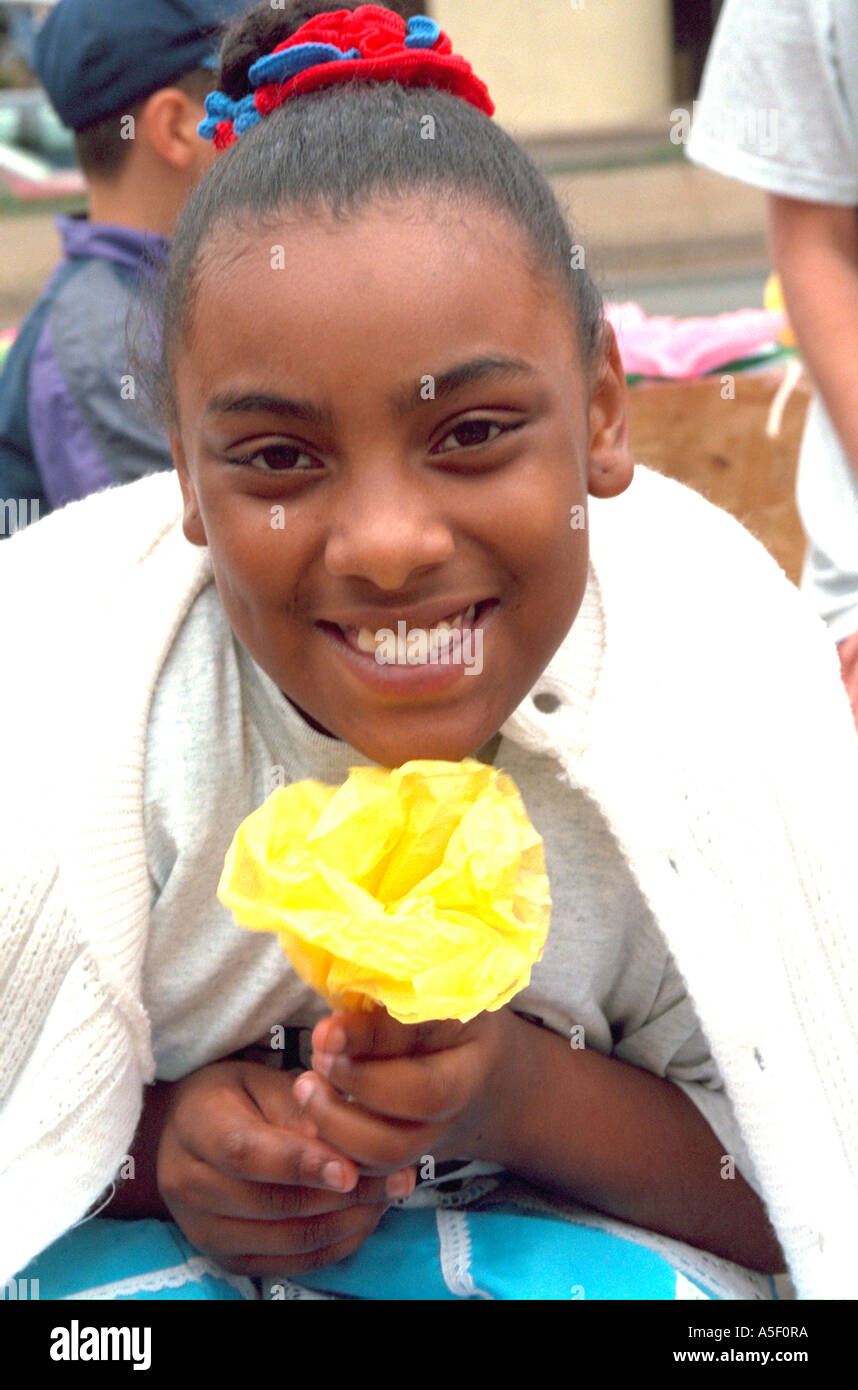 Teen girl age 13 holding paper flower at Cinco de Mayo Festival. St Paul Minnesota USA Stock Photo