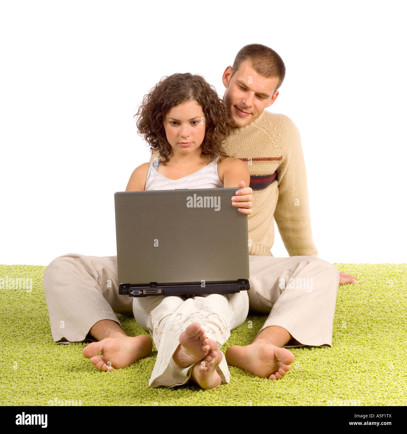 isolated on white young couple on green carpet with laptop Stock Photo ...