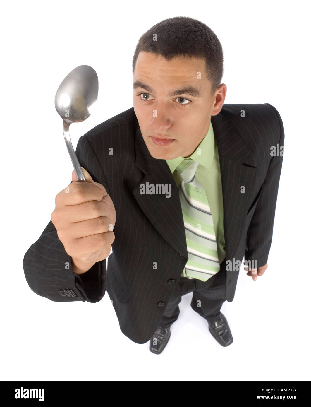 isolated on white businessman bending spoon by mind force Stock Photo ...
