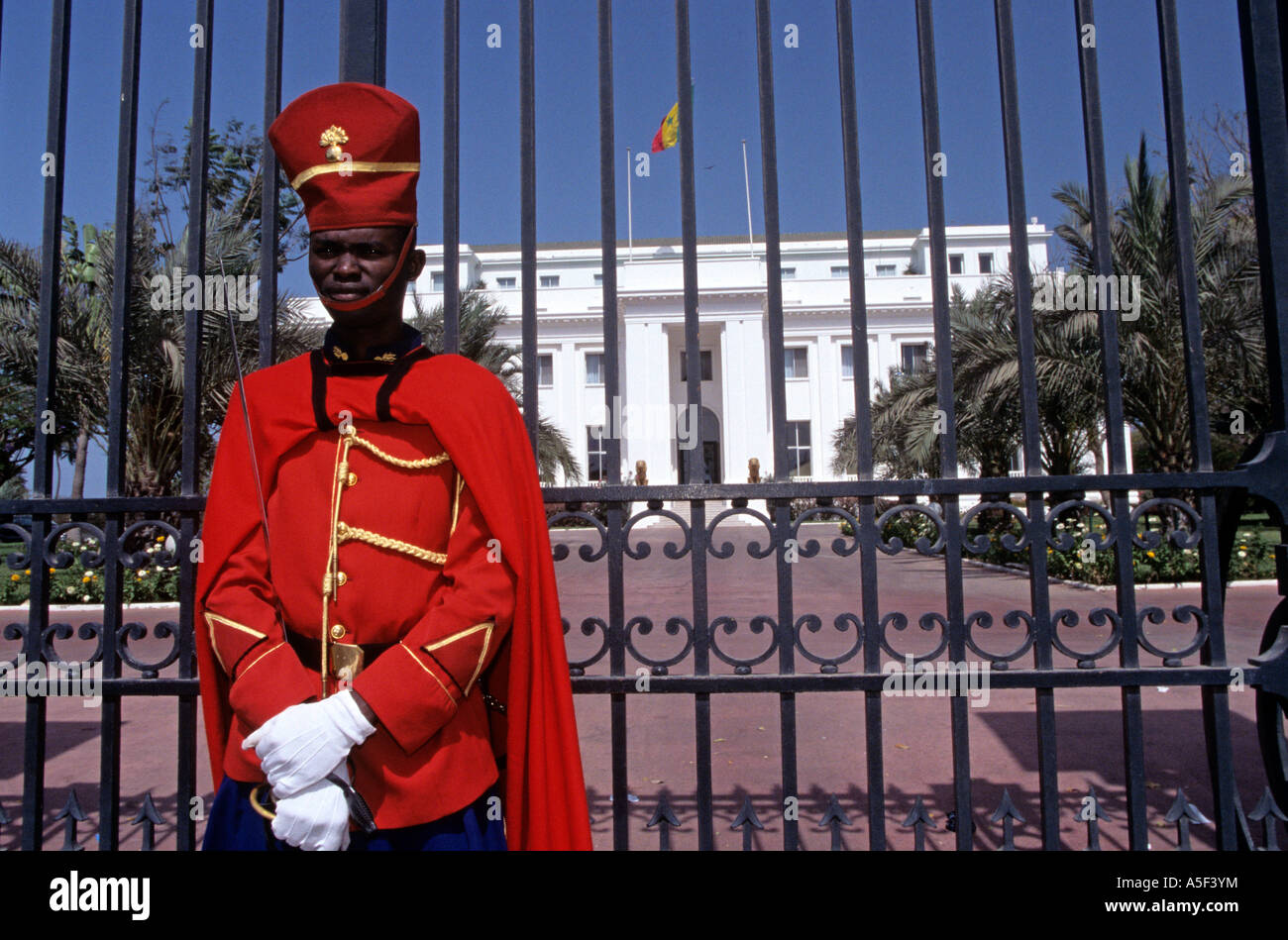 A soldier stands guad in front of the President s Palace in Dakar Senegal Stock Photo