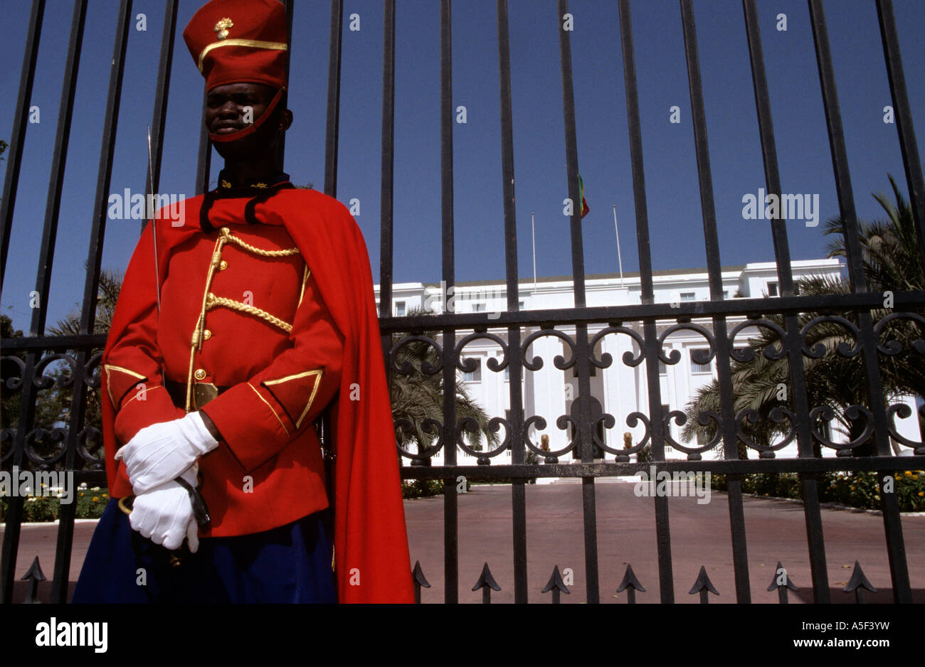 A soldier stands guard in front of the President s Palace in Dakar Senegal Stock Photo