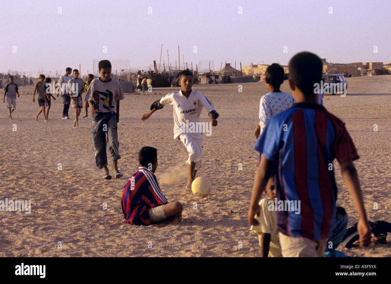 Group of Saharawi refugee children playing soccer at camp, Tindouf, Western Algeria Stock Photo