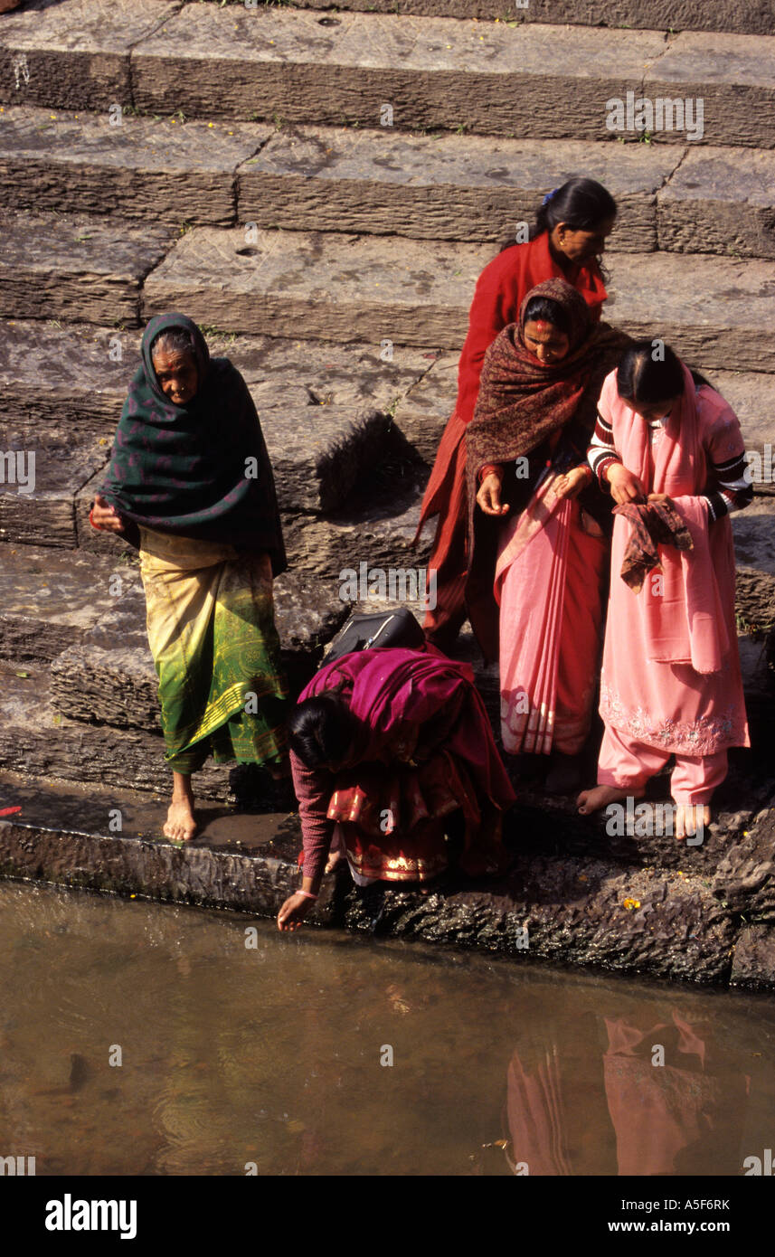 Women cleaning up in the Bagmati River in Kathmandu Nepal Stock Photo