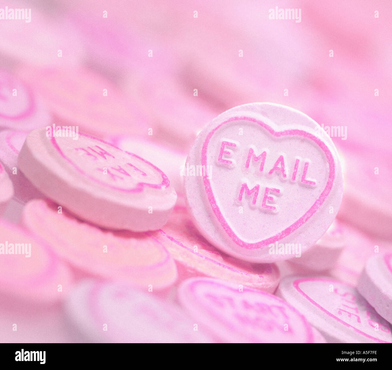 Pink sweets with E MAIL ME text Stock Photo