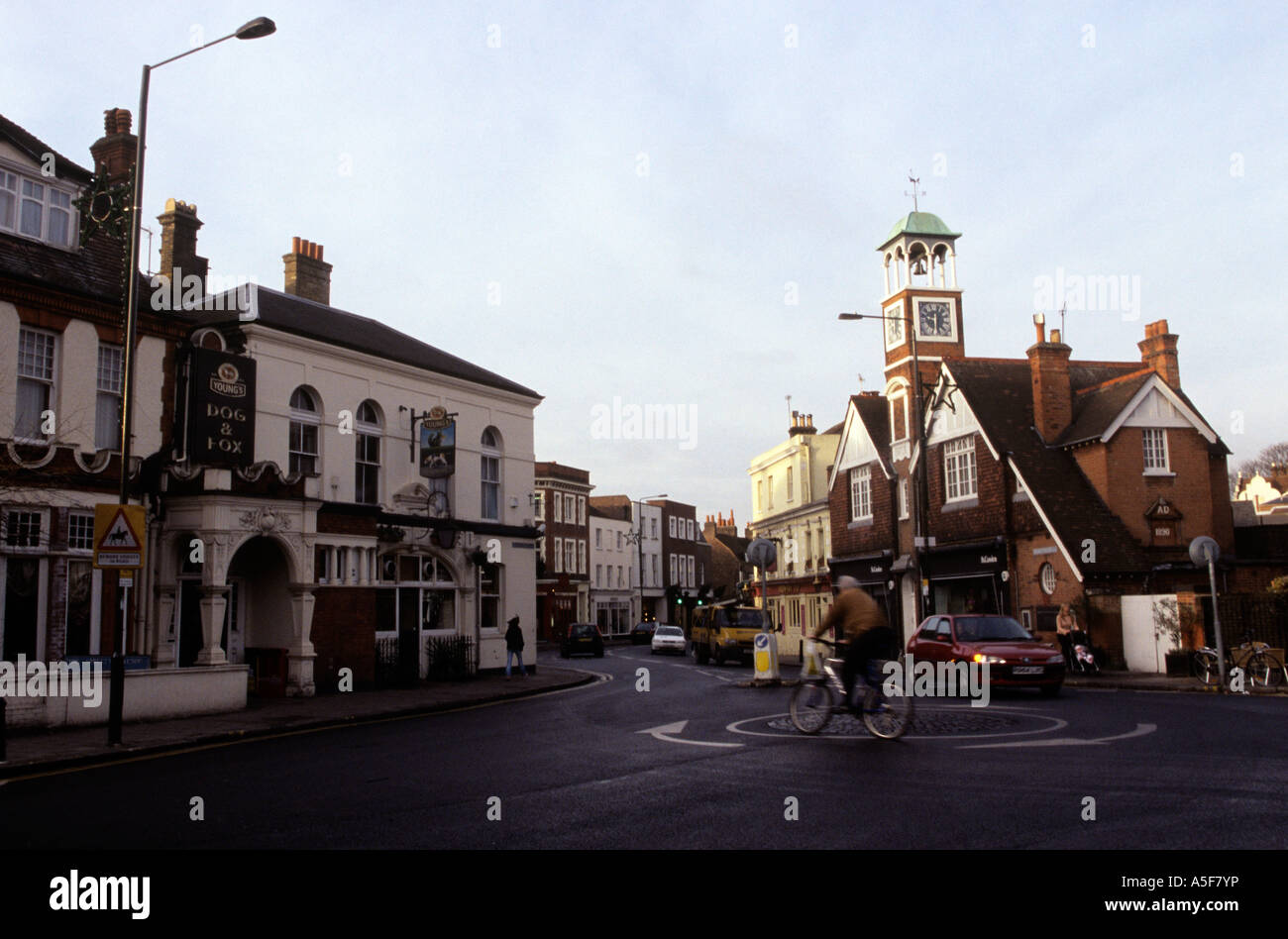 Vehicles go past on a road in Wimbledon London Stock Photo