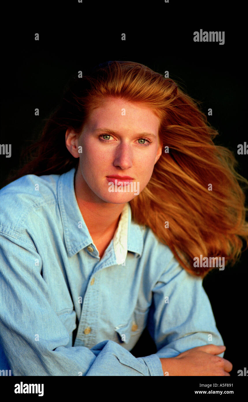 Portrait of woman with red hair in blue denim shirt Stock Photo