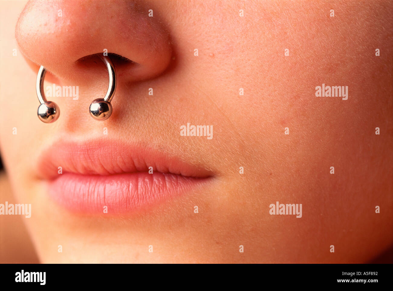 Woman with ring through pierced nasal septum Stock Photo - Alamy