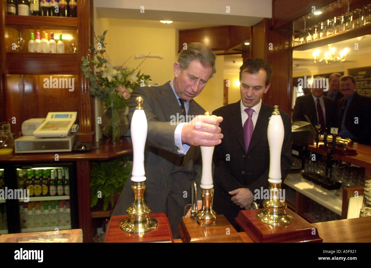 Prince Charles pulls a pint at the Poet Laureate Pub in Poundbury Dorset Stock Photo