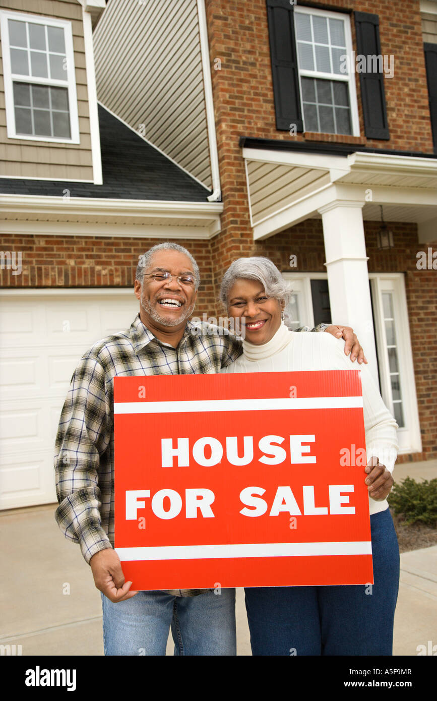 Portrait of middle aged African American couple outside house with for ...
