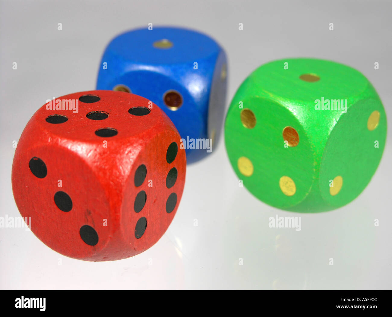 Three wooden coloured Dice Stock Photo