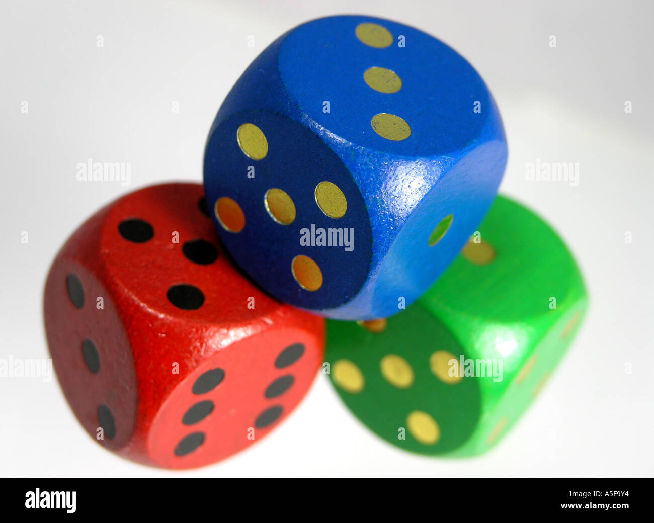 Three wooden dice piled Stock Photo