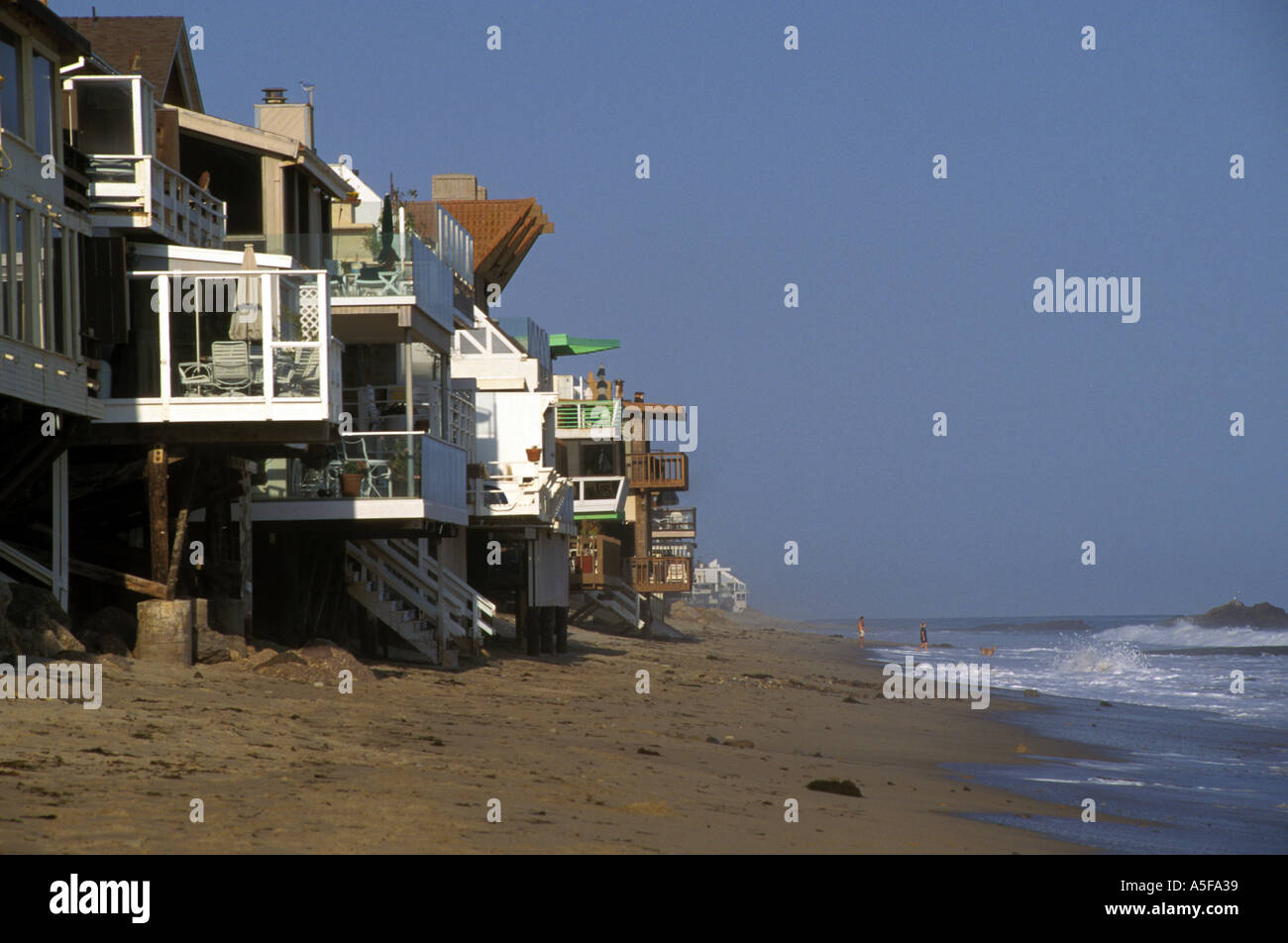 California Malibu view along beach of houses on stilts near water edge