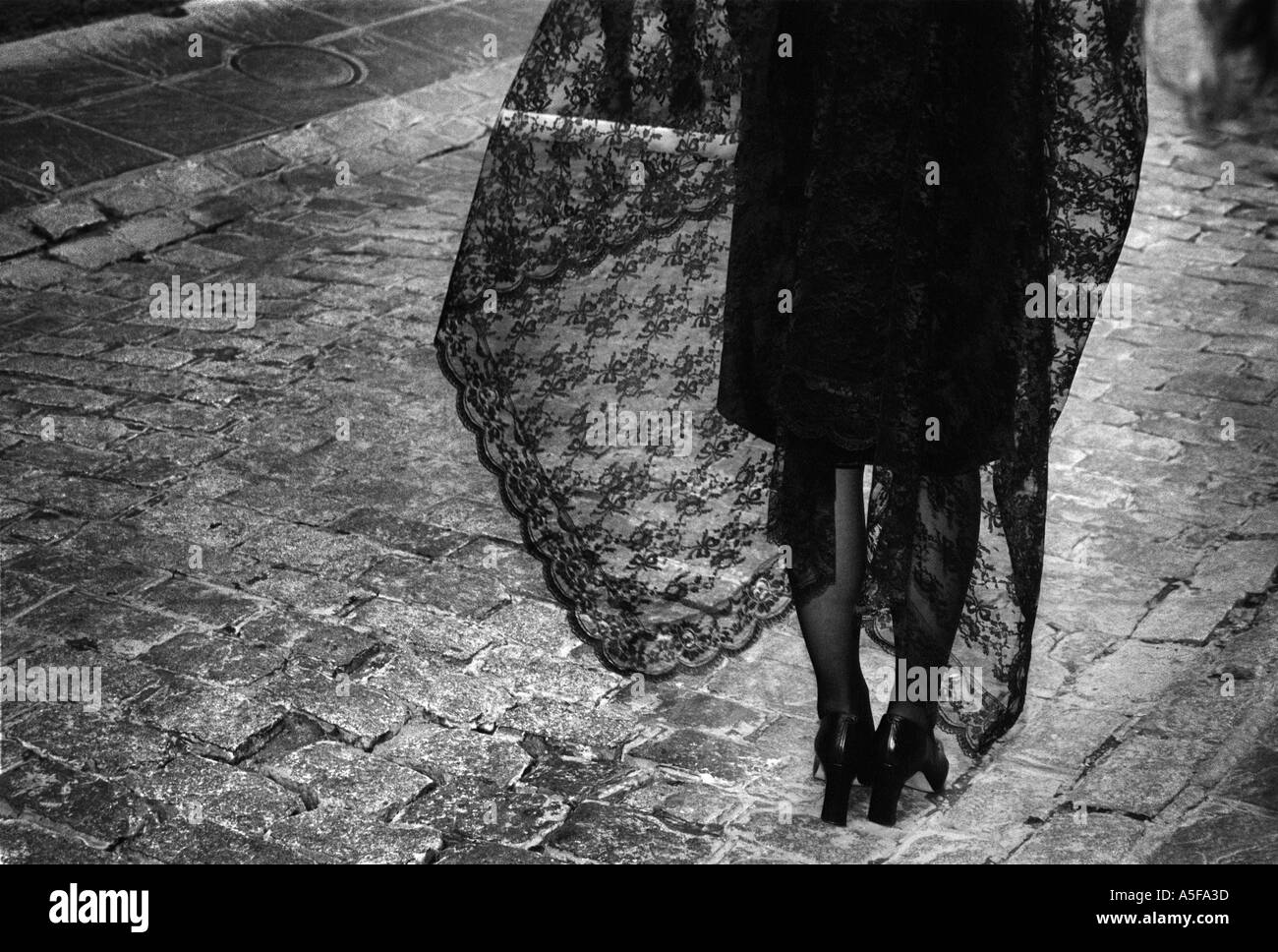 Woman in Black Shawl with Candle in Easter Procession in Spain Stock Photo