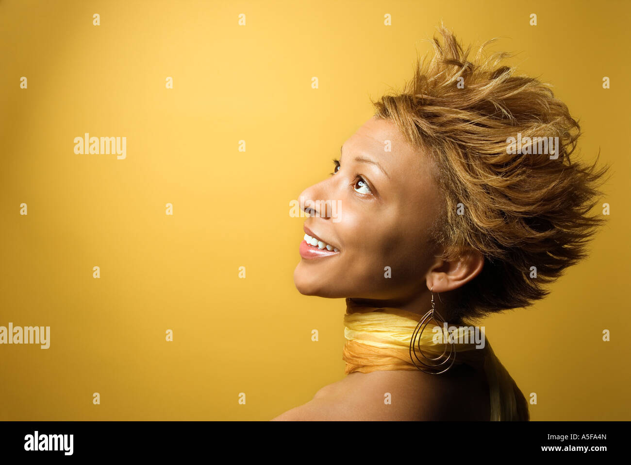 Side view portrait of smiling young African American adult woman on ...