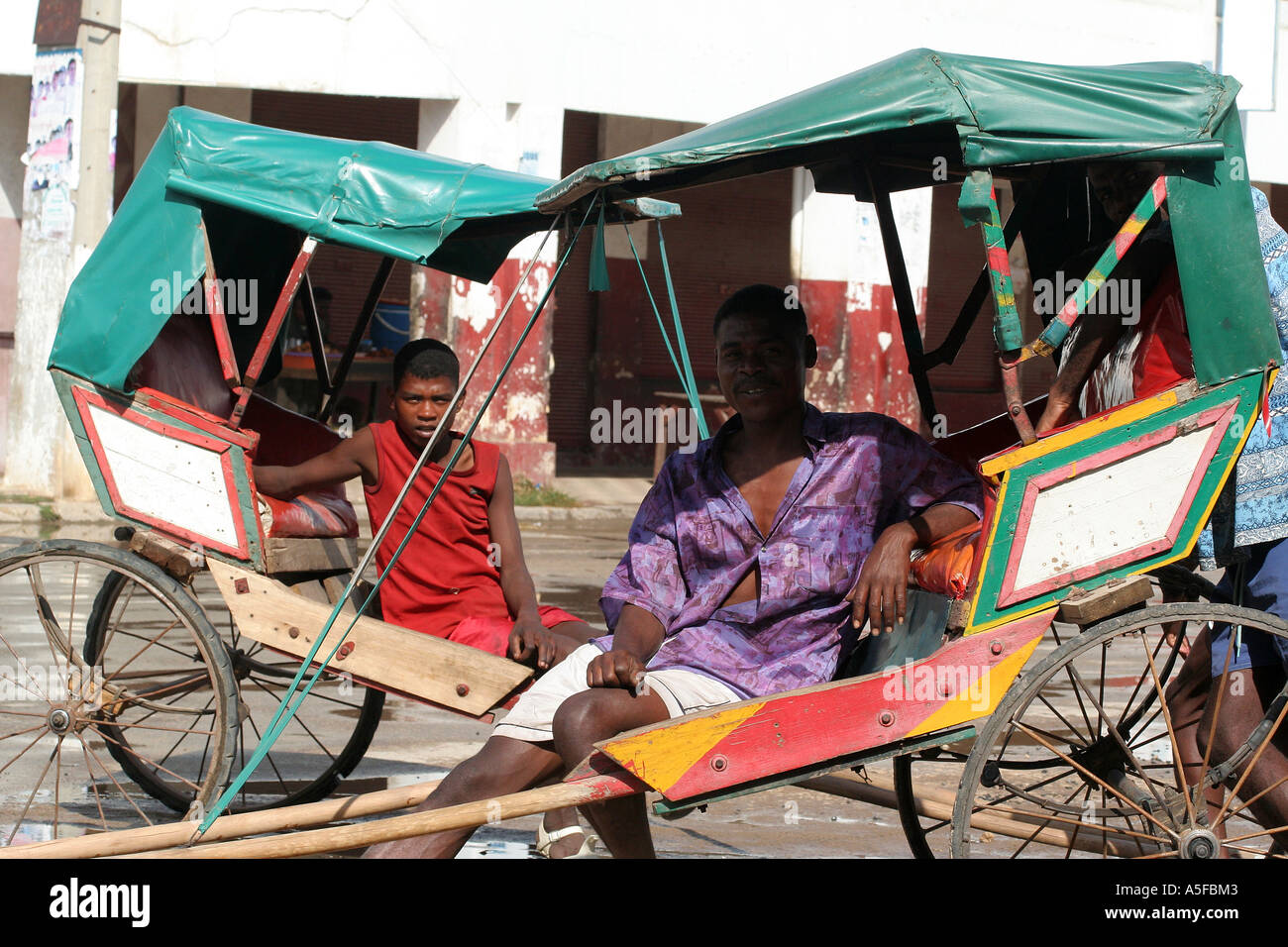 Madagascar, Pousse Pousse, peditaxi, pullers relax on their cabs, Toliara ( Tulear ) Stock Photo