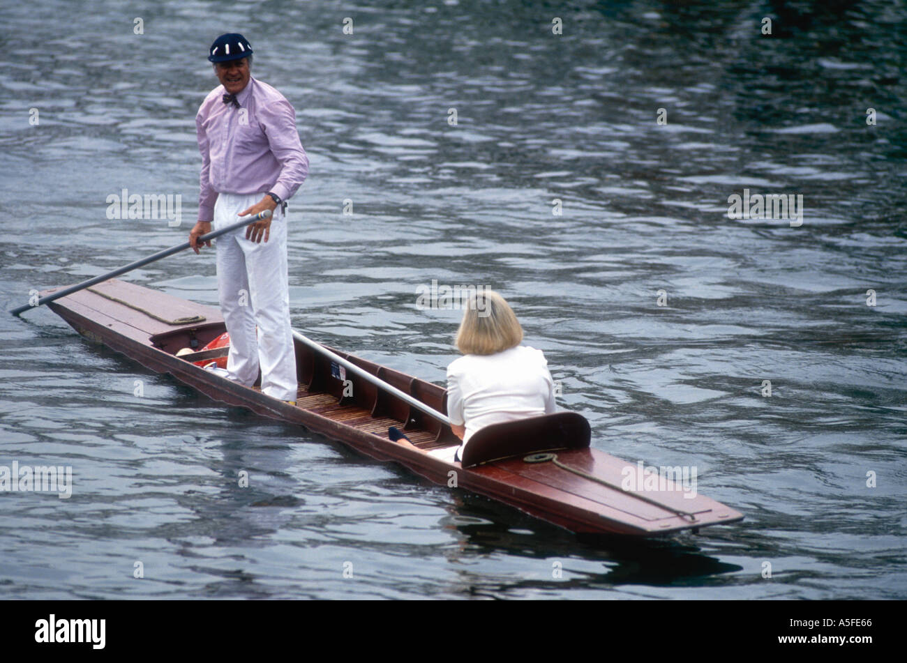 Man and woman in a punt at at Henley Royal Regatta on the River Thames in Oxfordshire England UK Stock Photo