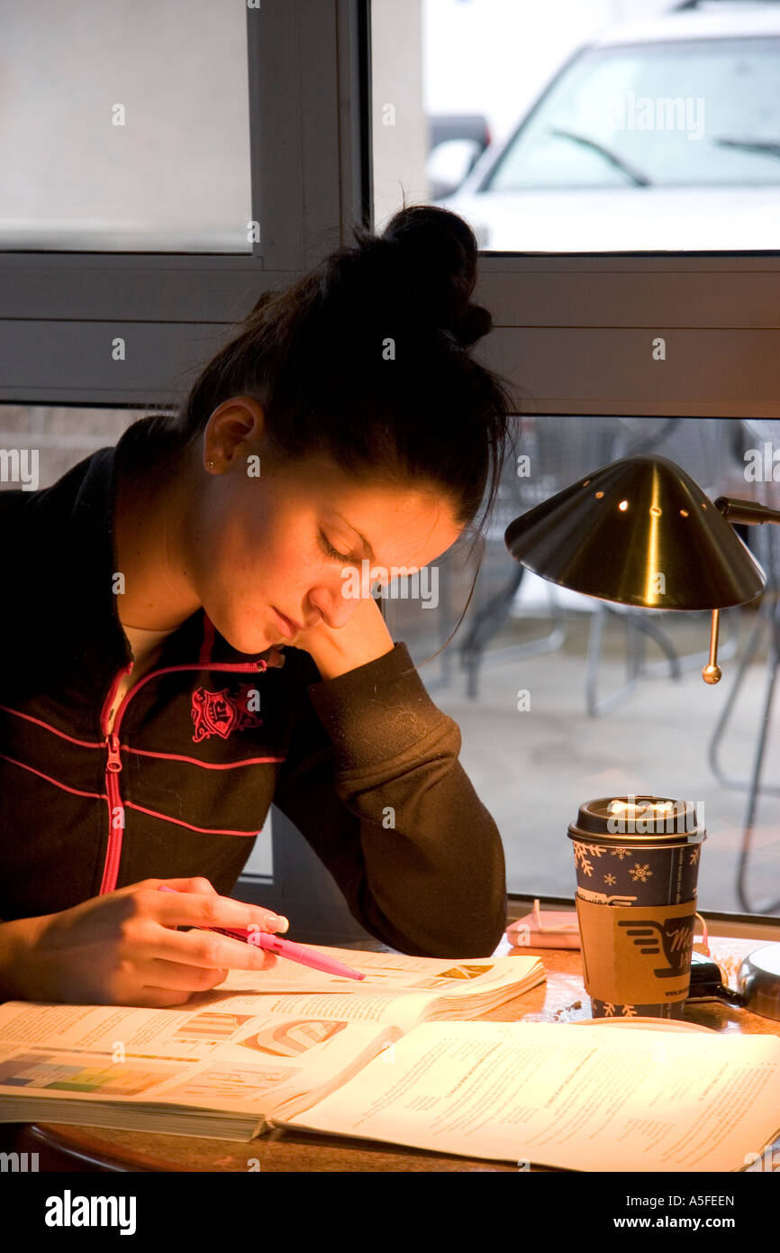 Female college student studying at a coffee shop in Boise Idaho Stock Photo