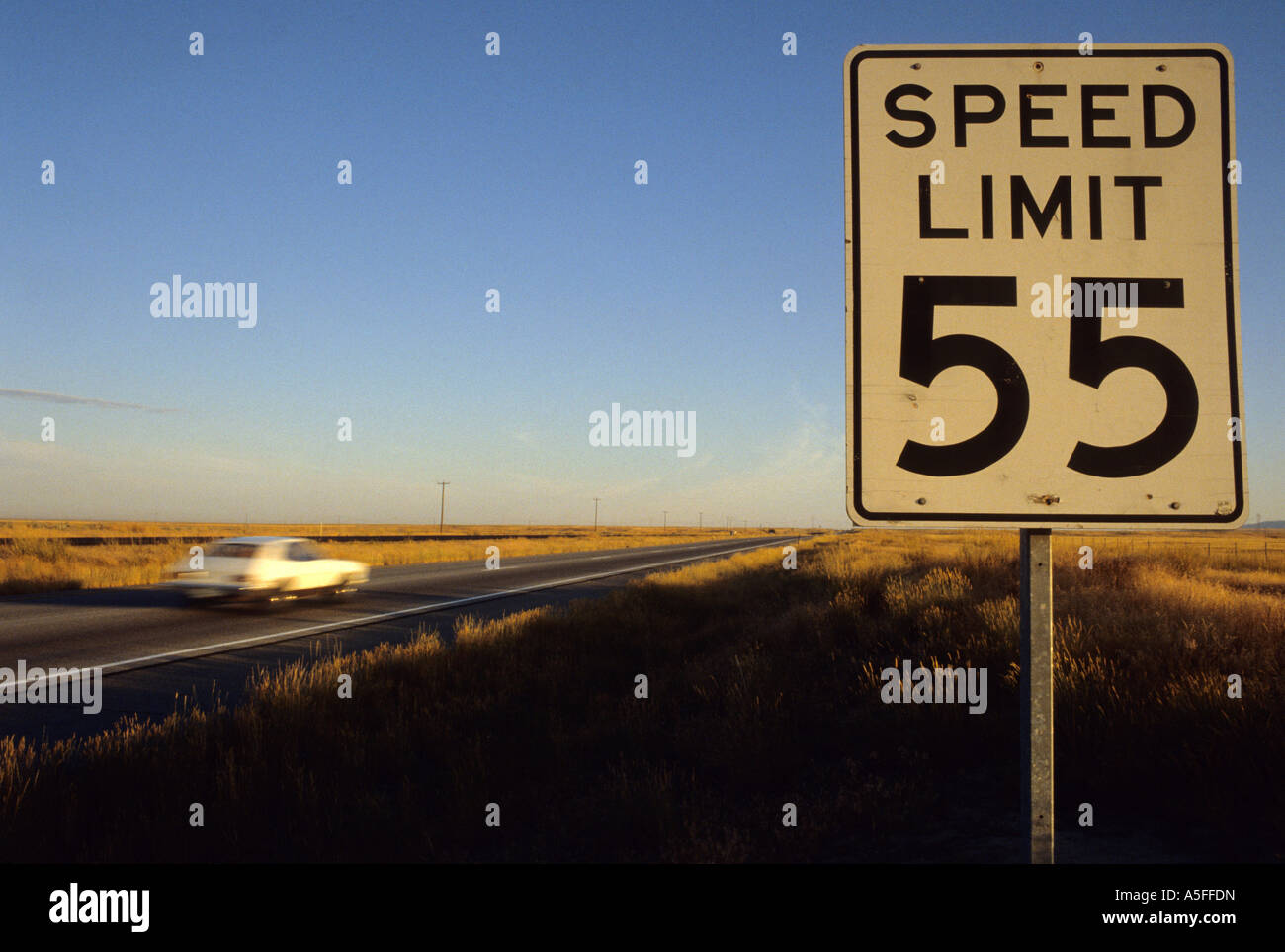 Speed limit 55 sign with traffic on the interstate in Idaho Stock Photo