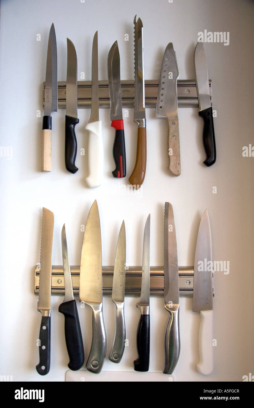 Kitchen knives displayed on magnetic strips Stock Photo