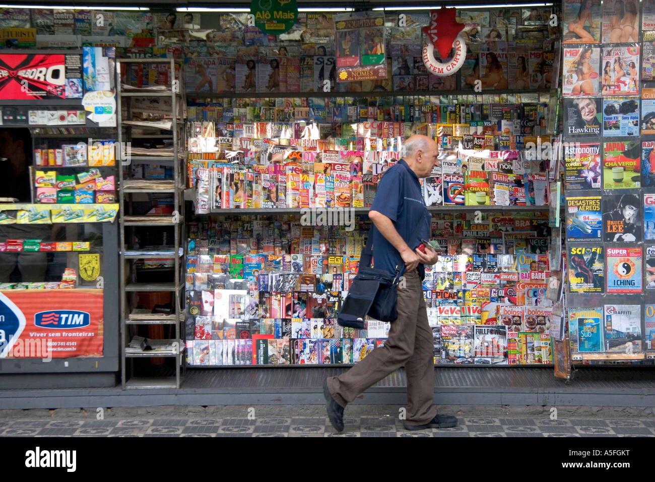 A man walks past a newsstand in the Liberdade asian section of Sao Paulo Brazil Stock Photo