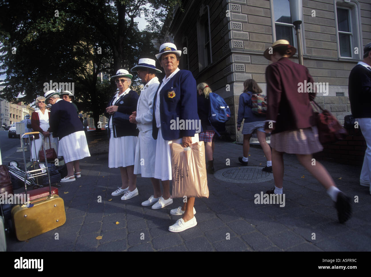 Australia Tasmania Ladies Lawn Bowls players wait at bus stop in
