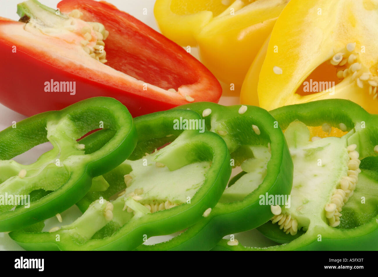Sliced red yellow and green sweet bell peppers Stock Photo - Alamy