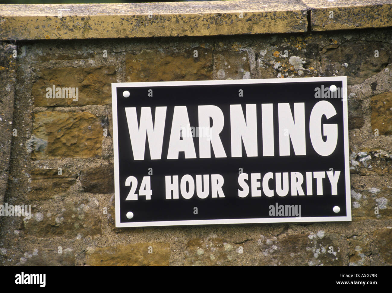 Security warning sign 24 hours 24 7 England HOMER SYKES Stock Photo