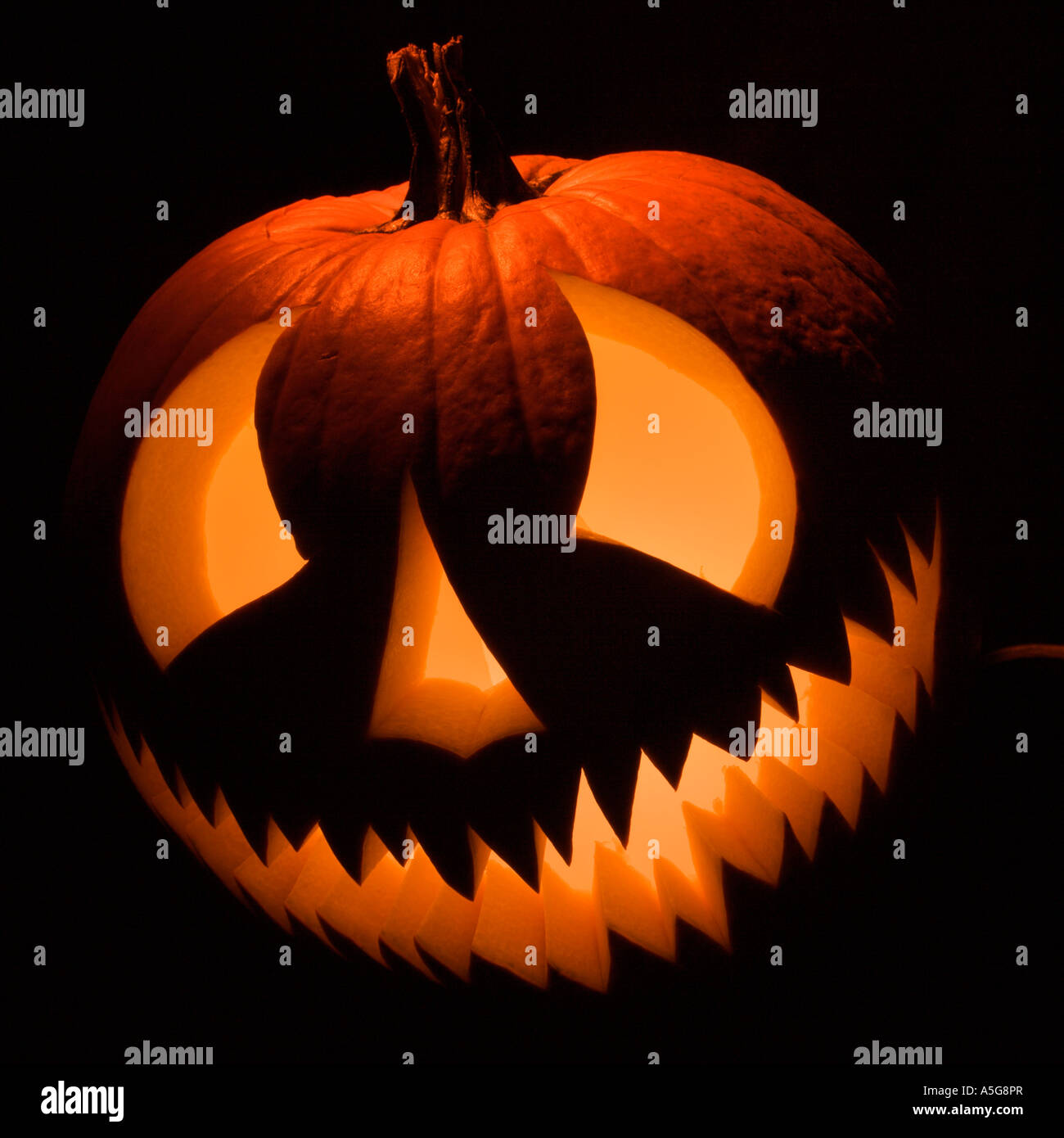 Carved Halloween pumpkin glowing in the dark Stock Photo - Alamy
