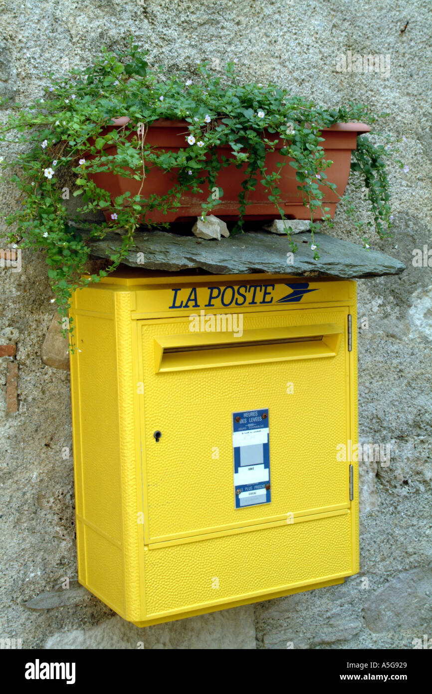 French Yellow Letter Box with a display of flowers Le Poste Postbox