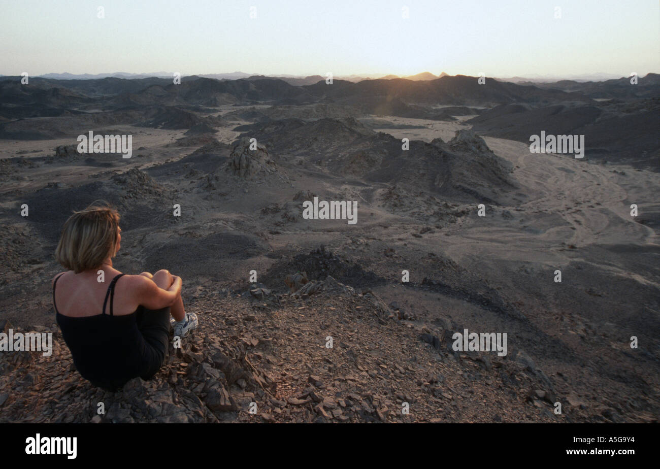 Woman watching sunset in desert hi-res stock photography and images - Alamy