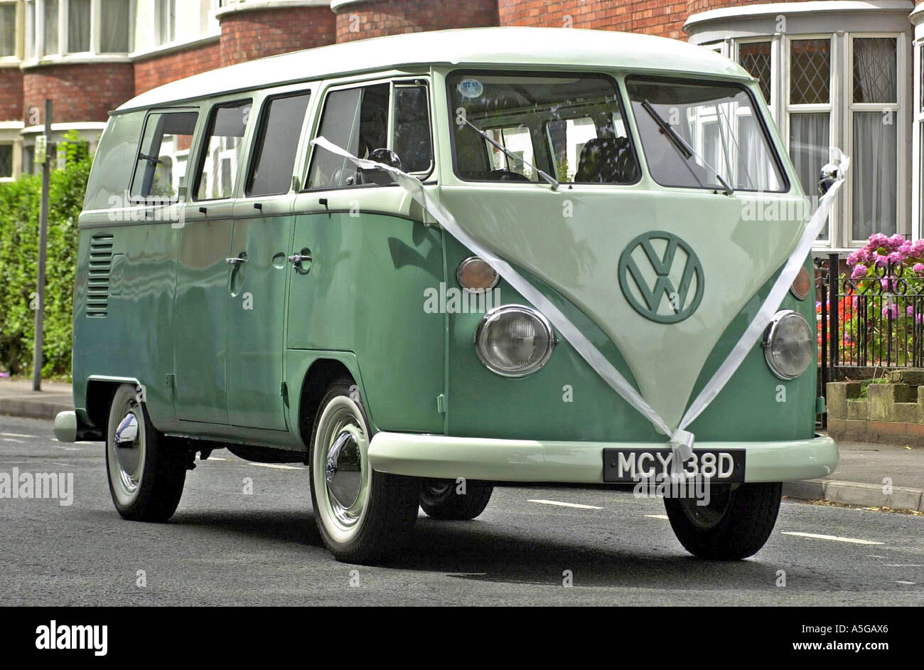 Old Split Screen Volkswagen camper van with bow being used as a wedding  vehicle Stock Photo - Alamy