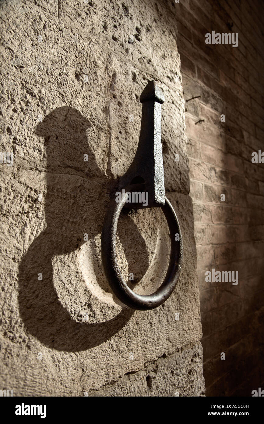 Metal hitching post on stone wall Stock Photo - Alamy