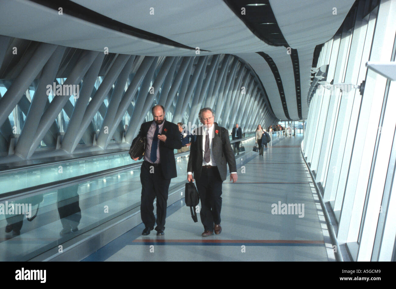 Two businessmen walking across the airbridge LGW Gatwick North Terminal London airports BAA British Airports Authority Stock Photo