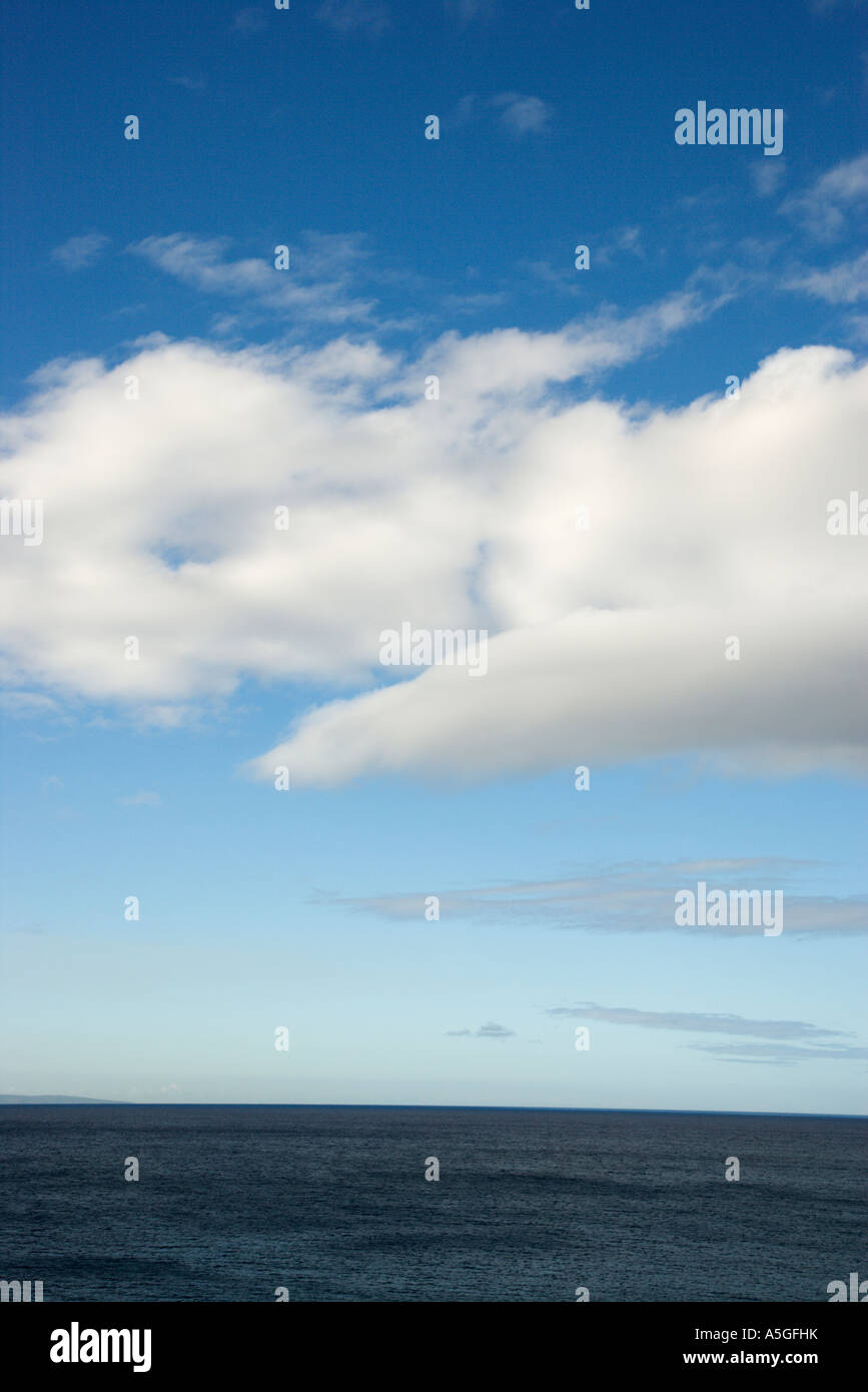 Blue sky with fluffy white clouds over ocean horizen Stock Photo - Alamy