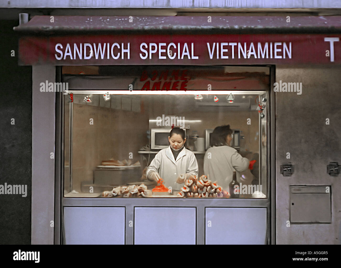 An employee prepares sandwiches in a Vietnamese restaurant in the 13th district of Paris Stock Photo