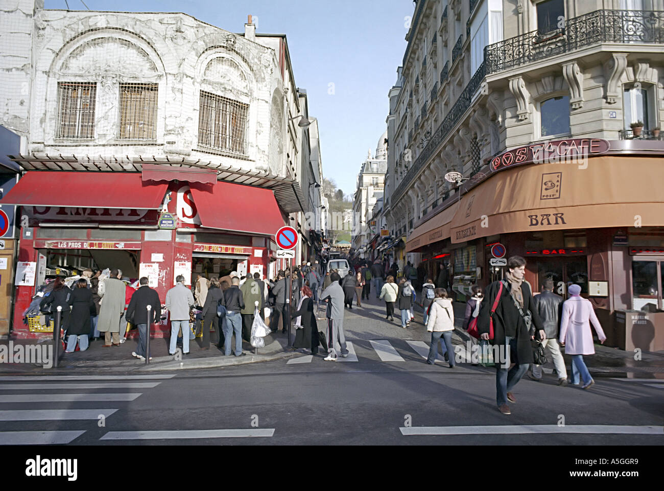 Shoppers crowd the sidewalks of Belleville Paris during the winter sales Stock Photo