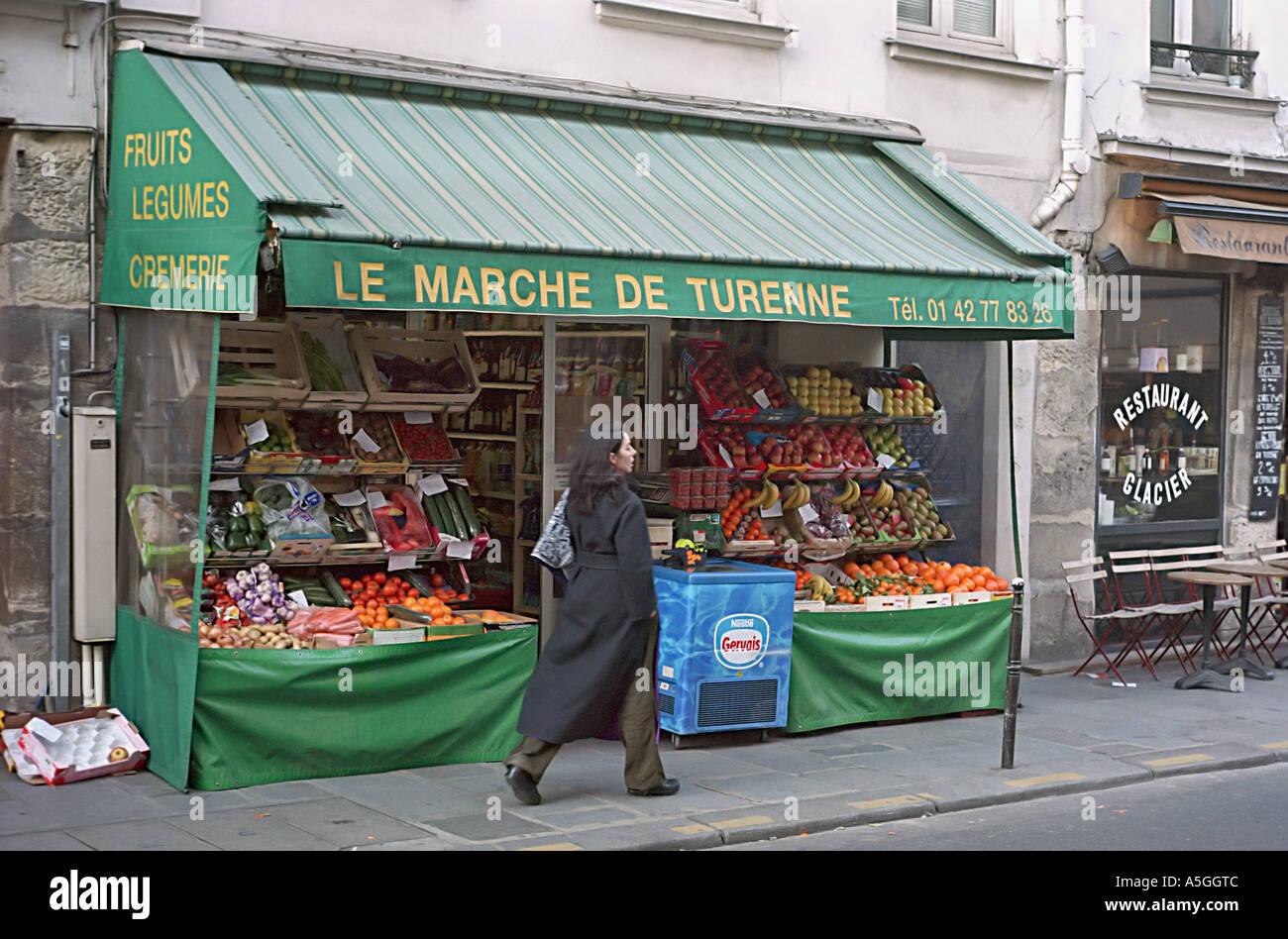 A typical French grocery store in Paris offering a sidewalk display of fruits and vegetables Stock Photo